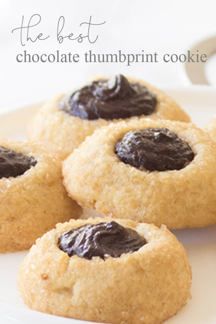 These wonderful Chocolate Thumbprint Cookies are rolled in turbinado sugar for a sweet crunchy outer layer. The chocolate ganache is a perfect pairing to the awesome little cookie. Baking | Cookie Recipe | Recipes | Desserts | Cookie | Chocolate Ganache | Cookies | Homemade Cookies | Best Cookies | Chocolate Cookie