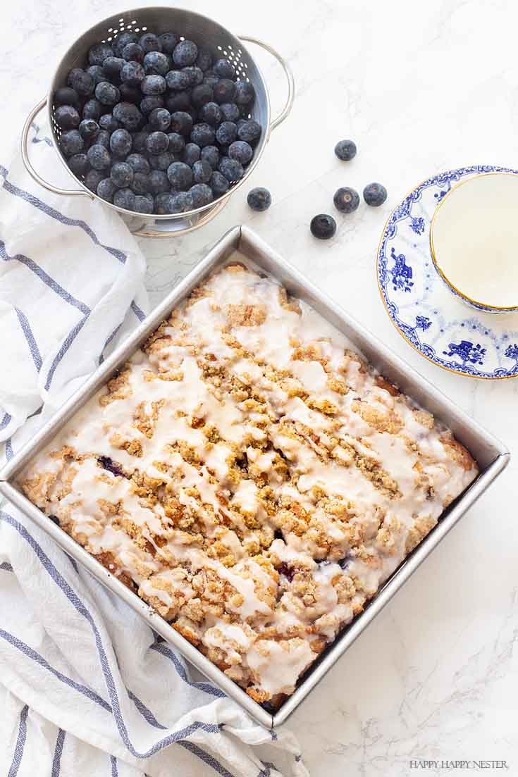 This New England dessert is The Best Blueberry Buckle Cake Recipe and is sure the perfect side to a cup of coffee or tea. Serve it as a dessert or as a morning blueberry coffee cake. This easy recipe makes an impressive cake with the crumble and delicious icing. #cake #coffeecake #blueberrydessserts #blueberries #desserts #pastry 