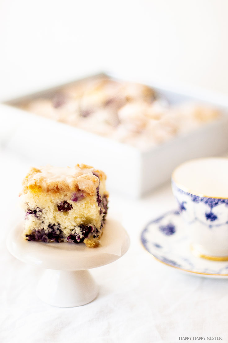 Need a yummy cake recipe? This dessert is The Best Blueberry Buckle Cake Recipe and is sure the perfect side to a cup of coffee or tea. Serve it as a dessert or as a morning blueberry coffee cake. This easy recipe makes an impressive cake with the crumble and delicious icing. #cake #coffeecake #blueberrydessserts #blueberries #desserts #pastry 