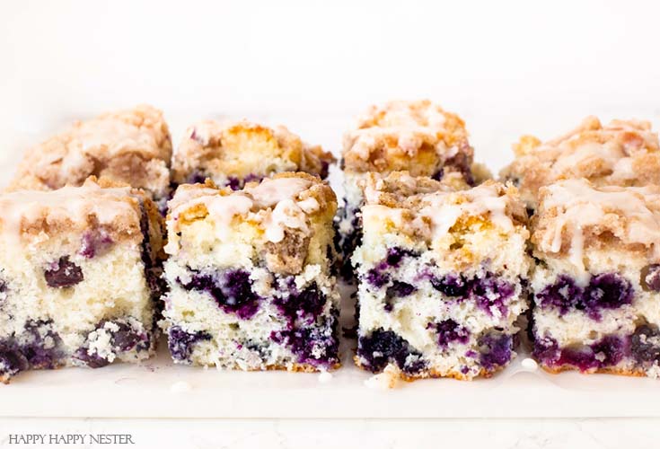 Make this great cake! This dessert is The Best Blueberry Buckle Cake Recipe and is sure the perfect side to a cup of coffee or tea. Serve it as a dessert or as a morning blueberry coffee cake. This easy recipe makes an impressive cake with the crumble and delicious icing. #cake #coffeecake #blueberrydessserts #blueberries #desserts #pastry 