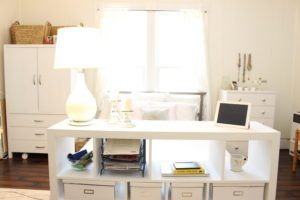 small studio bookshelf near bed