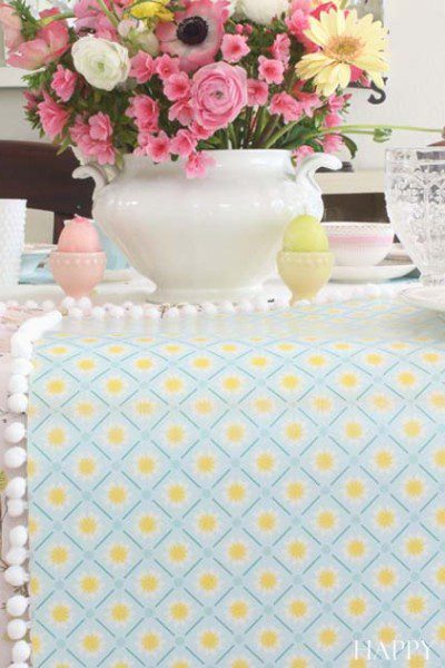 This unique paper table runner is easy to make and cute. It would dress up any table either at home or at a wedding. Make this inexpensive craft in minutes.