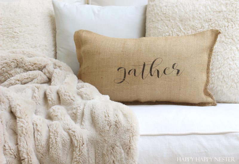 a burlap pillow that says gather