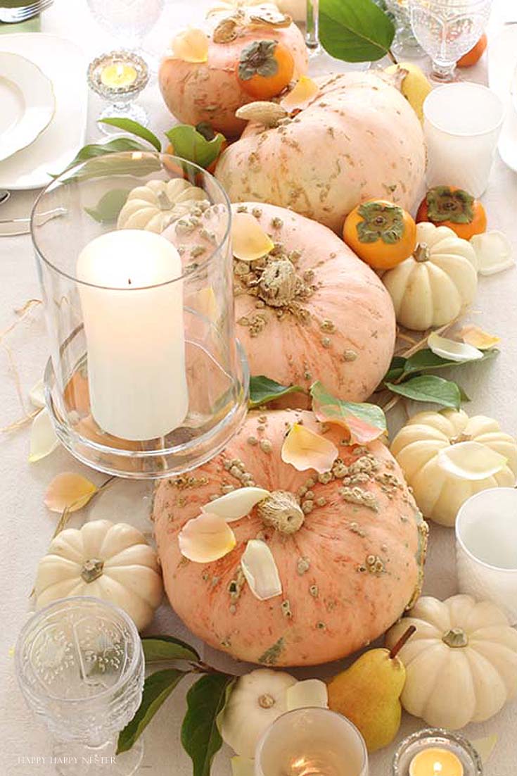 a table with pink and cream pumpkins
