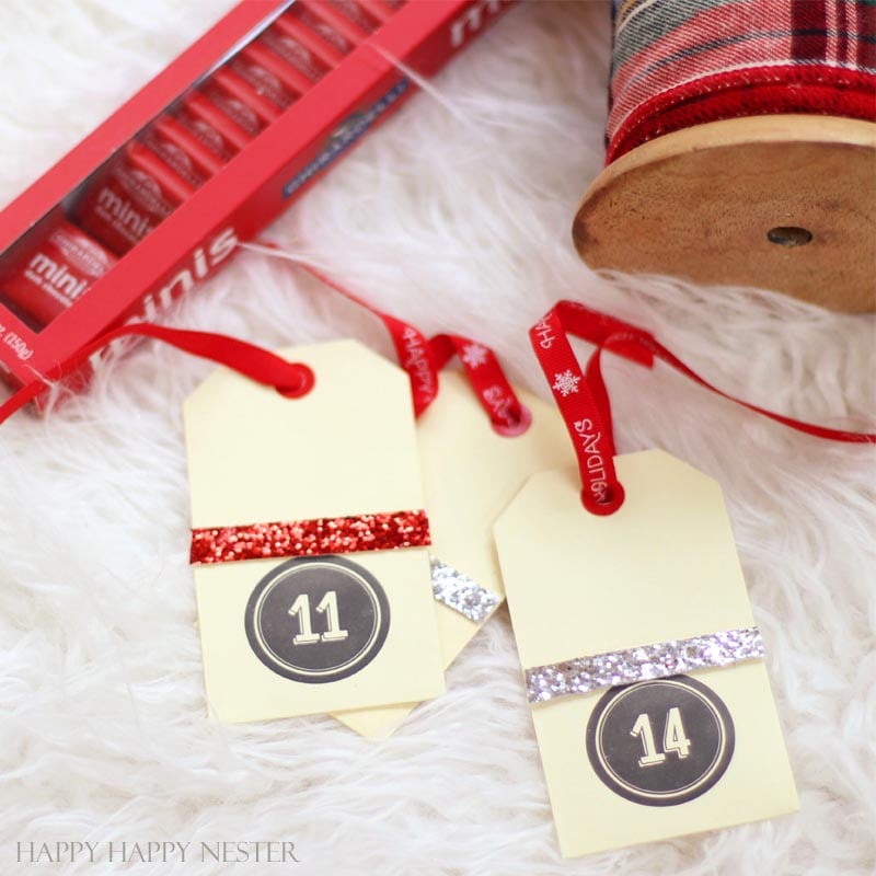 DIY Advent Tree uses your own Christmas tree. Place cute envelopes with numbers and fill with treats. This is the easiest advent tree you'll ever create!