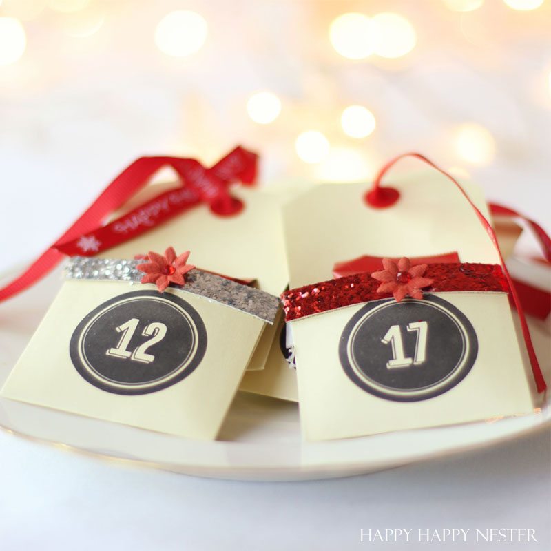 DIY Advent Tree uses your own Christmas tree. Place cute envelopes with numbers and fill with treats. This is the easiest advent tree you'll ever create!