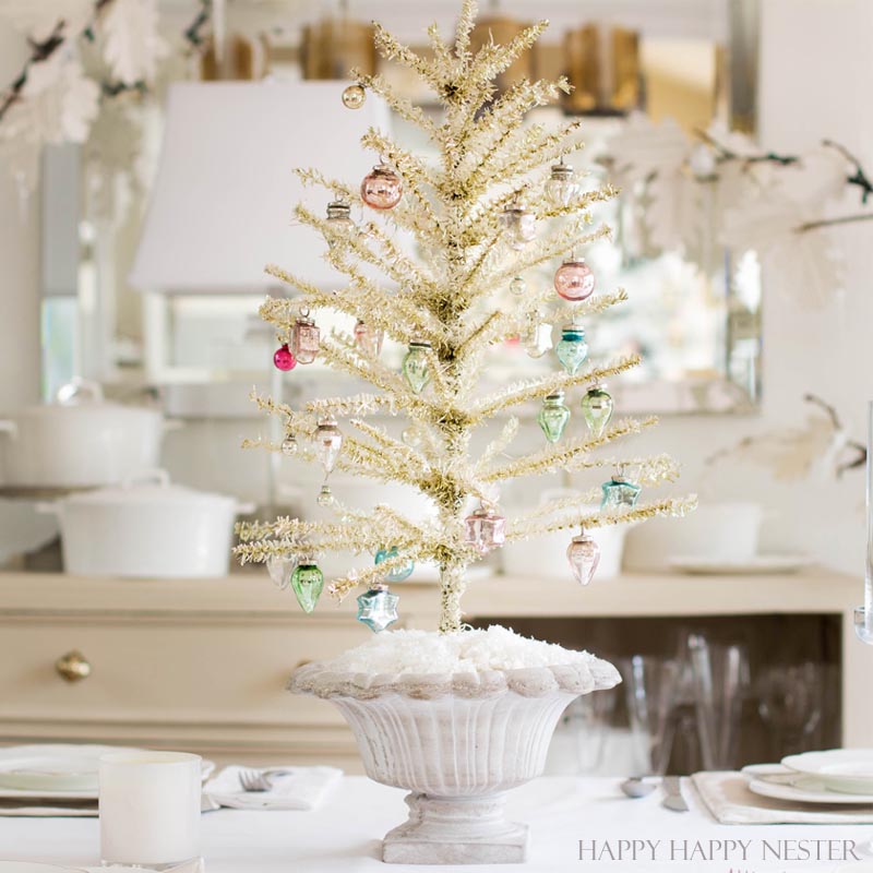 This is an easy way to make a Feather Tree. You take a tinsel tree and give it a good haircut. Then you add a bit of chalk paint to make it vintage like.