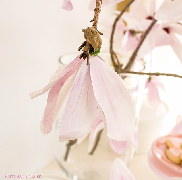 A magnolia paper flower tutorial you won't want to miss. I made this flower out of watercolor flower petals and added them to a tree branch, and you have lifelike flowers that you can make from paper. #DIY | #paperflowers | #crafts | #fauxflowers