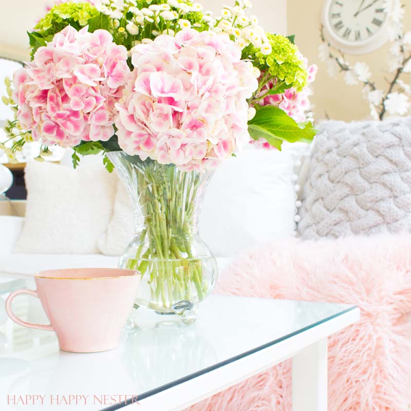 Decorating with pink is easy. Pink is getting a new look, and you should add some splashes in your home. I have two versions that introduce spring into my living room. I have some easy tips on quickly adding a few accents to your decor. Diy | decorating | blush | pink | millennials | trends