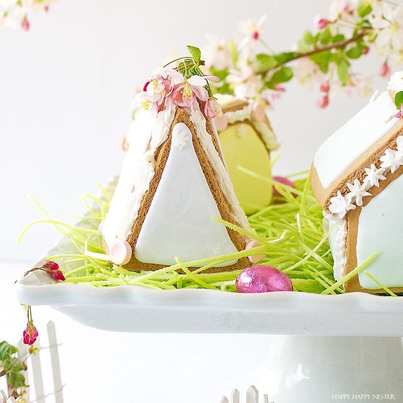 These adorable Easter Houses are perfect for spring. Make them from the mini-gingerbread kit, and you'll love this easy project. Place them on a cake stand and use them on your Easter or Spring table. Decorate them with icing and fun candies. You and your family will love this project. #spring #easter #diy #crafts