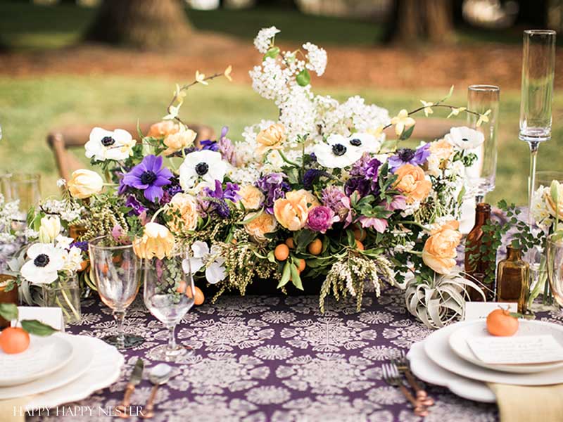 Take your spring table setting outdoors and add some gorgeous flower centerpieces to create a memorable setting. With my step by step way to build your table, you can have a lovely outdoor table ready for entertaining. #diy #tabledecor #tablescape #springdecor #springtable #springtablesetting #flowercenterpieces