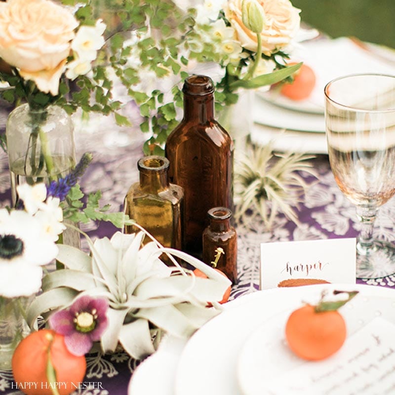 Take your spring table setting outdoors and add some gorgeous flower centerpieces to create a memorable setting. With my step by step way to build your table, you can have a lovely outdoor table ready for entertaining. #diy #tabledecor #tablescape #springdecor #springtable #springtablesetting #flowercenterpieces