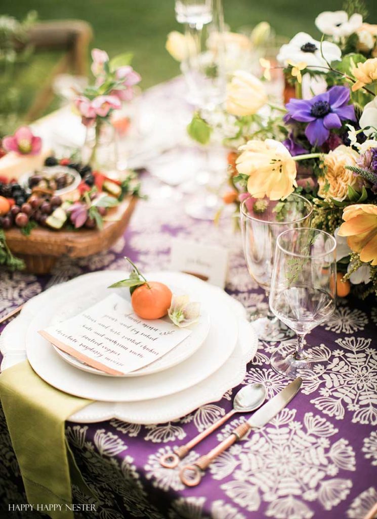 Take your spring table setting outdoors and add some gorgeous flower centerpieces to create a memorable setting. With my step by step way to build your table, you can have a lovely outdoor table ready for entertaining. #diy #tabledecor #tablescape #springdecor #springtable #springtablesetting #flowercenterpieces