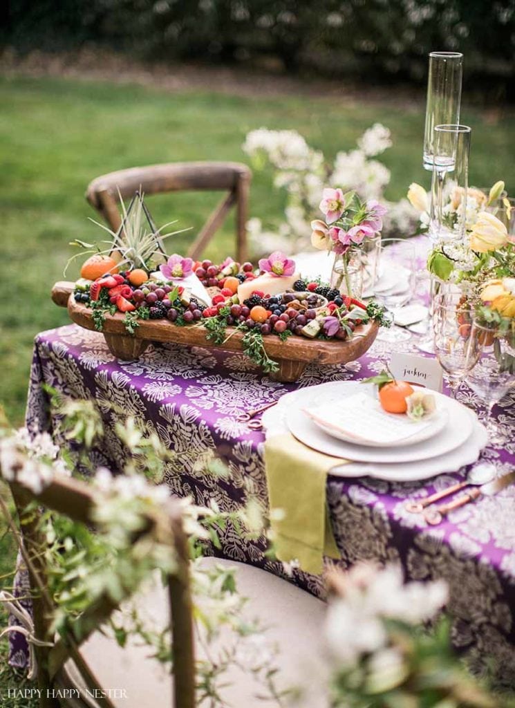 Take your spring table setting outdoors and add some gorgeous flower centerpieces to create a memorable setting. With my step by step way to build your table, you can have a lovely outdoor table ready for entertaining. #diy #tabledecor #tablescape #springdecor #springtable #springtablesetting #flowercenterpieces