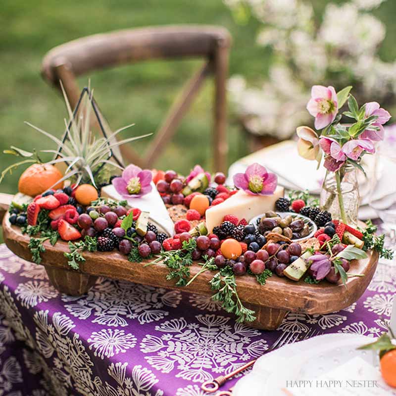 Take your spring table setting outdoors and add some gorgeous flower centerpieces to create a memorable setting. With my step by step way to build your table, you can have a lovely outdoor table ready for entertaining. #diy #tabledecor #tablescape #springdecor #springtable #springtablesetting #flowercenterpieces