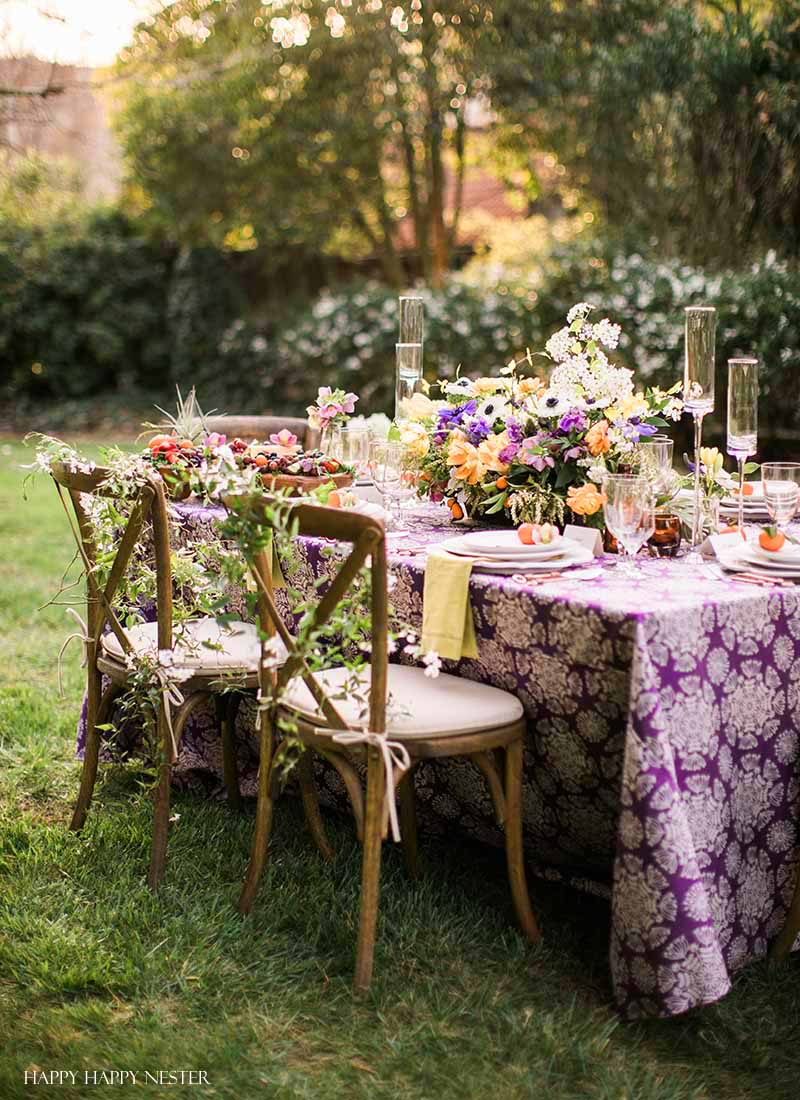 Take your spring table setting outdoors and add some gorgeous flower centerpieces to create a memorable setting. With my step by step way to build your table, you can have a lovely outdoor table ready for entertaining. #diy #tabledecor #tablescape #springdecor #springtable #springtablesetting #flowercenterpieces