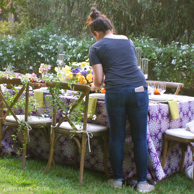 Take your spring table setting outdoors and add some gorgeous flower centerpieces to create a memorable setting. With my step by step way to build your table, you can have a lovely outdoor table ready for entertaining. #diy #tabledecor #tablescape #springdecor #springtable #springtablesetting #flowercenterpieces