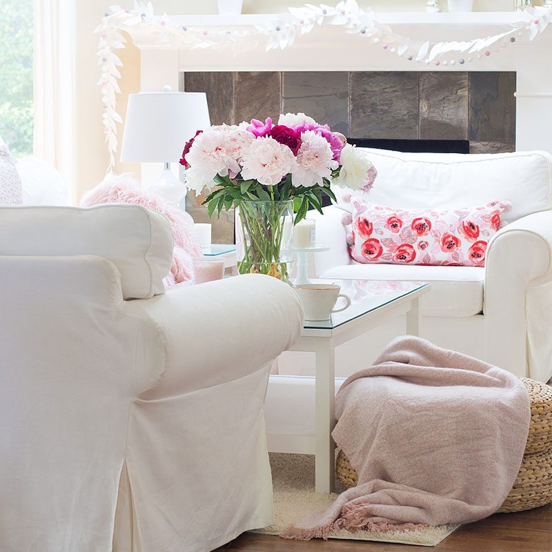 pink living room decor with peonies on a coffee table