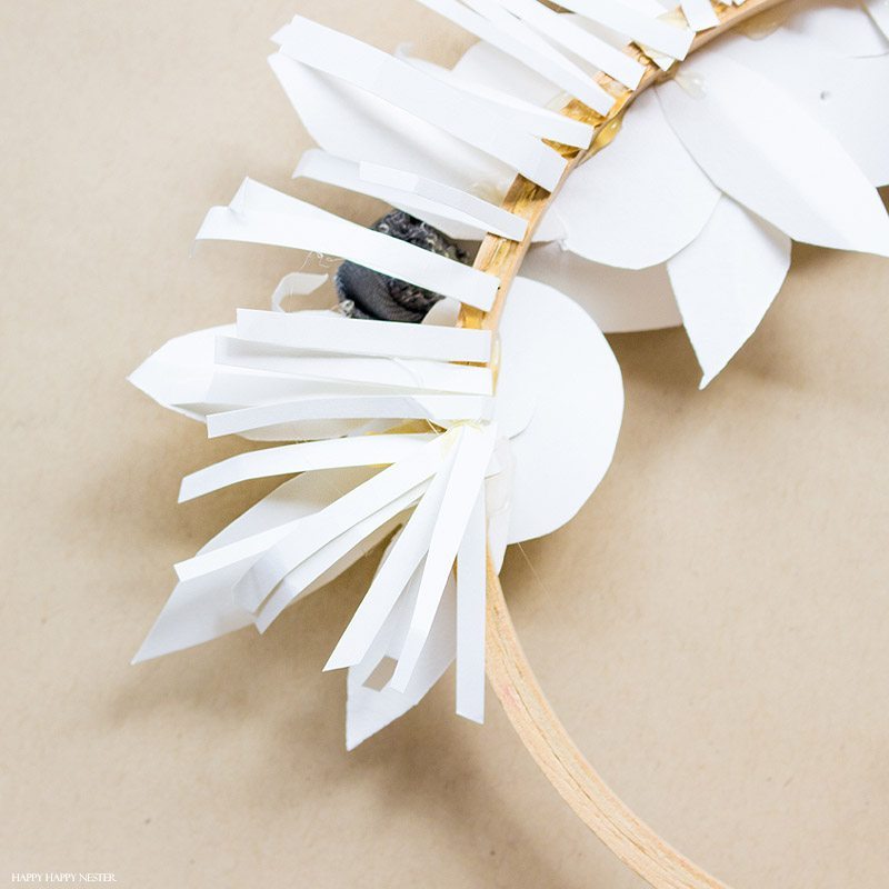 If you want a beautiful white paper wreath that will go with any decor, then you will love my latest paper craft. This paper flower project isn't that difficult, and the result is a beautiful year-round wreath. Make a few rosette paper flowers and leaves, and that's it. #crafts #papercrafts #diy #paper #paperflowers