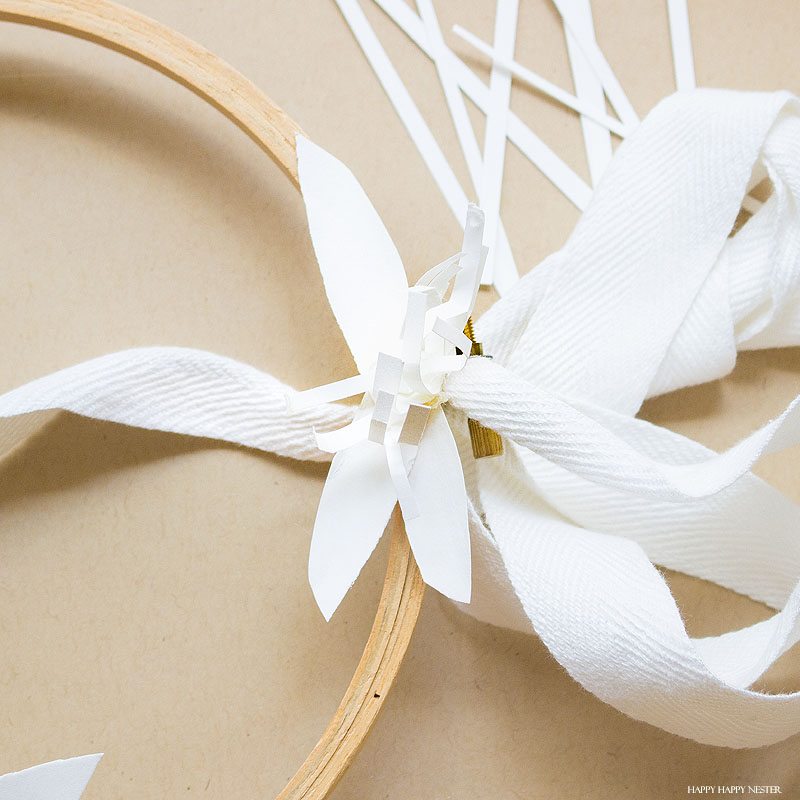 If you want a beautiful white paper wreath that will go with any decor, then you will love my latest paper craft. This paper flower project isn't that difficult, and the result is a beautiful year-round wreath. Make a few rosette paper flowers and leaves, and that's it. #crafts #papercrafts #diy #paper #paperflowers