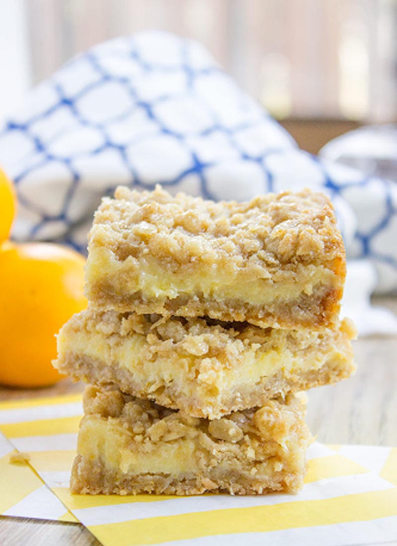 3 lemon crumb bars stacked on top of each other on a kitchen table