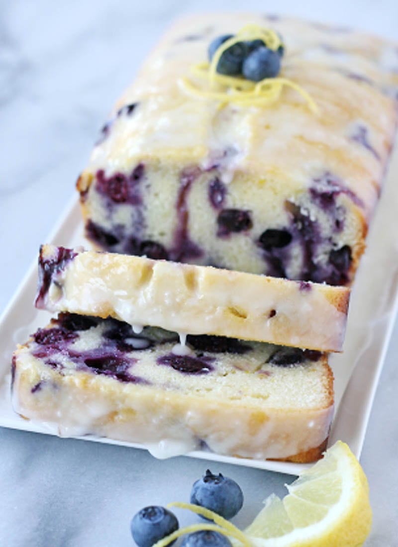 Lemon blueberry cake loaf sliced and on a white platter