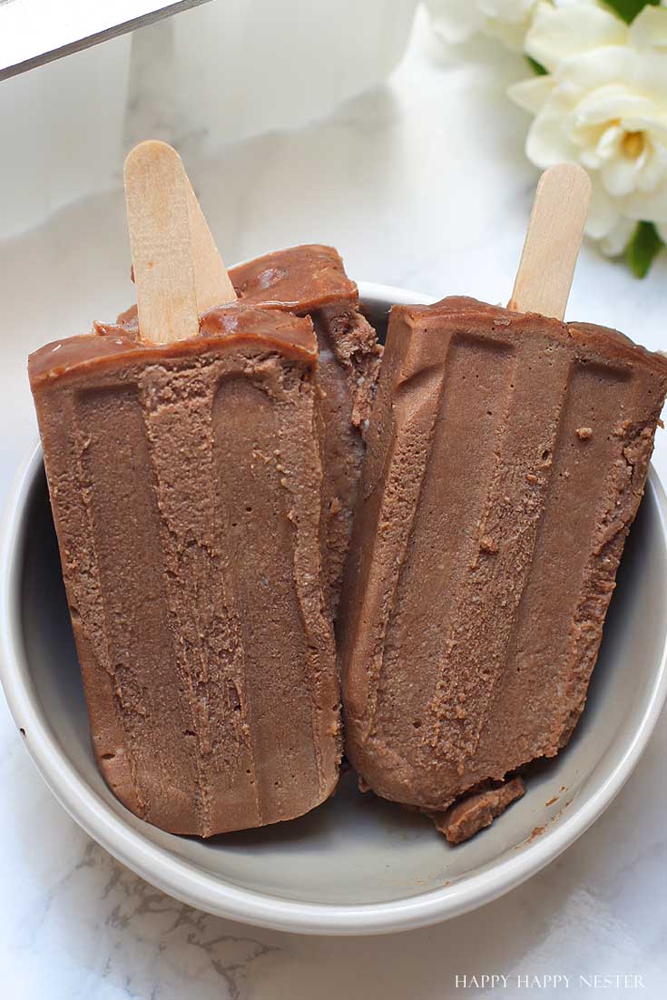 three homemade popsicles in a bowl