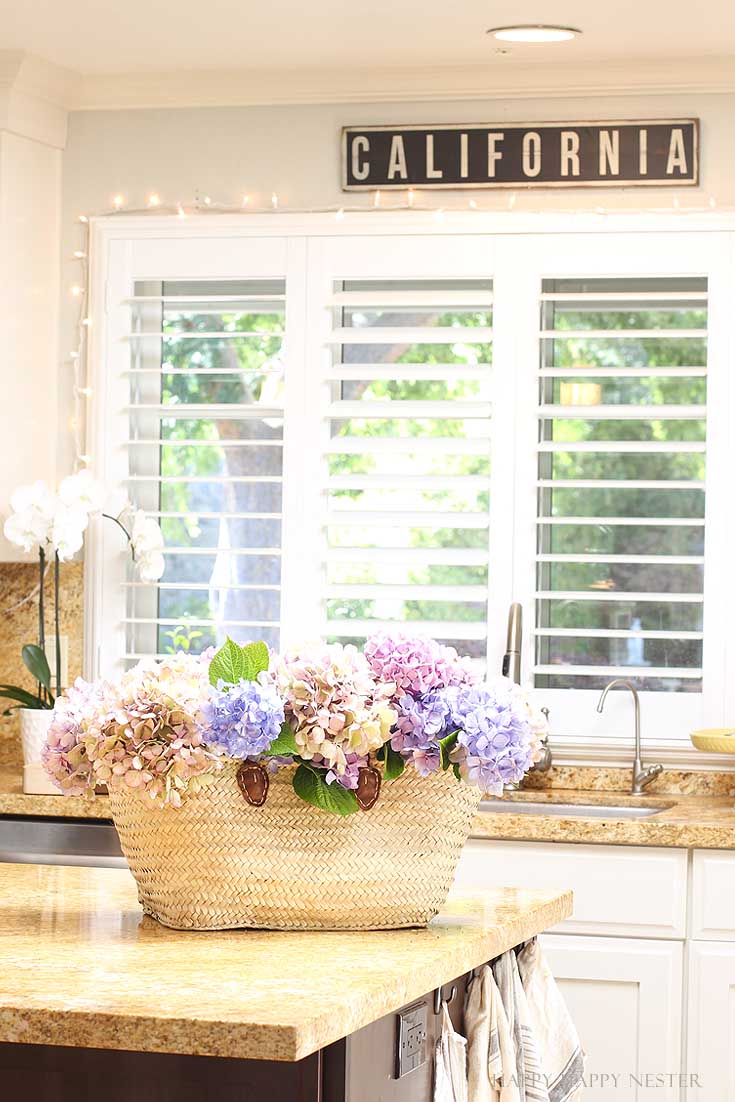 basket full of flowers on a kitchen island
