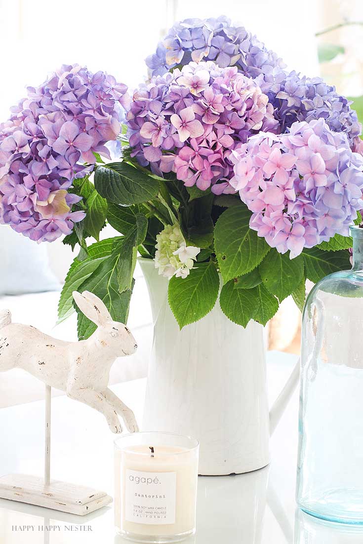 white pitcher with purple hydrangeas