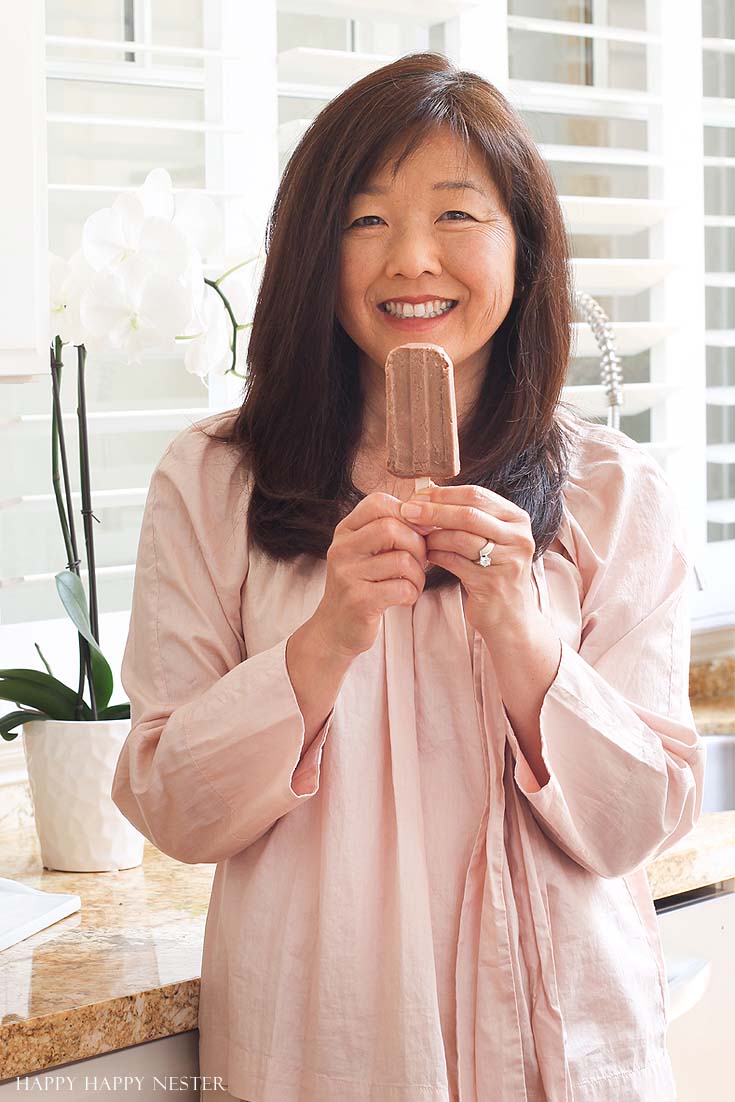 woman holding a chocolate popsicle