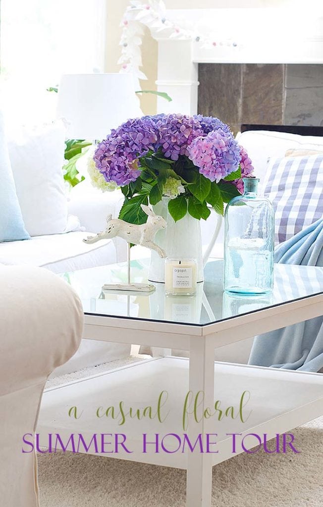 pinterest image with a white living room and purple flowers