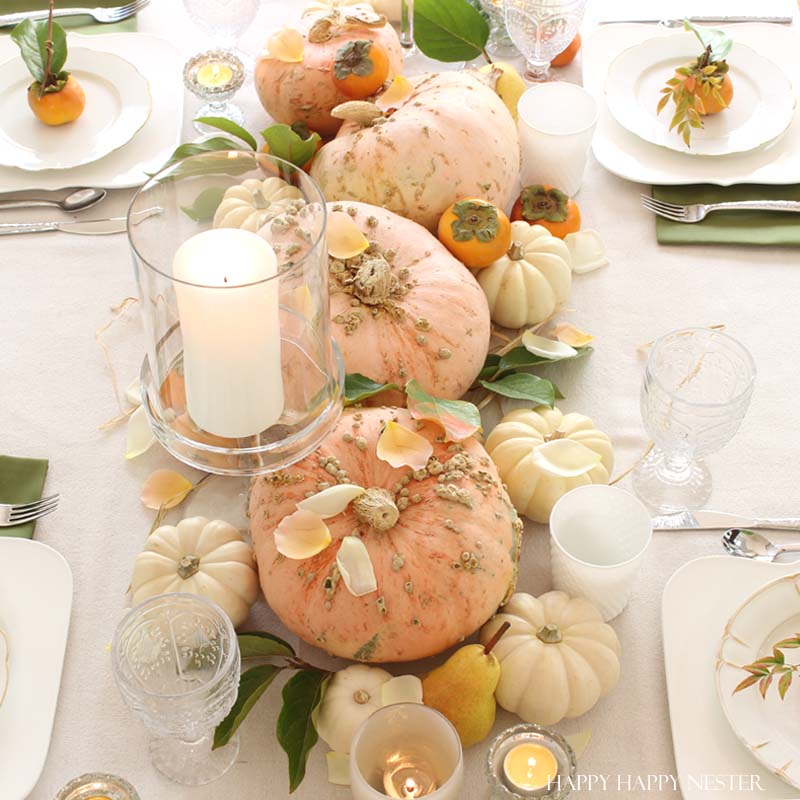 a collection of pink pumpkins on a white fall tablescapes