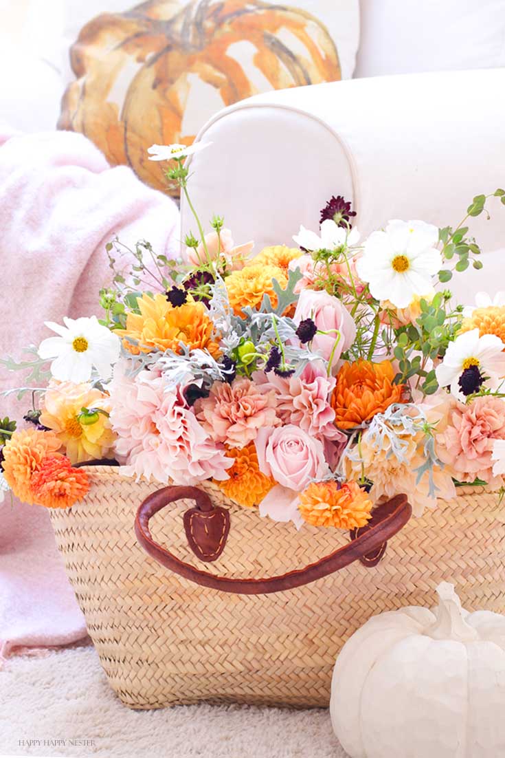 Basket full of orange and pink flowers in my fall home tour with untraditional colors