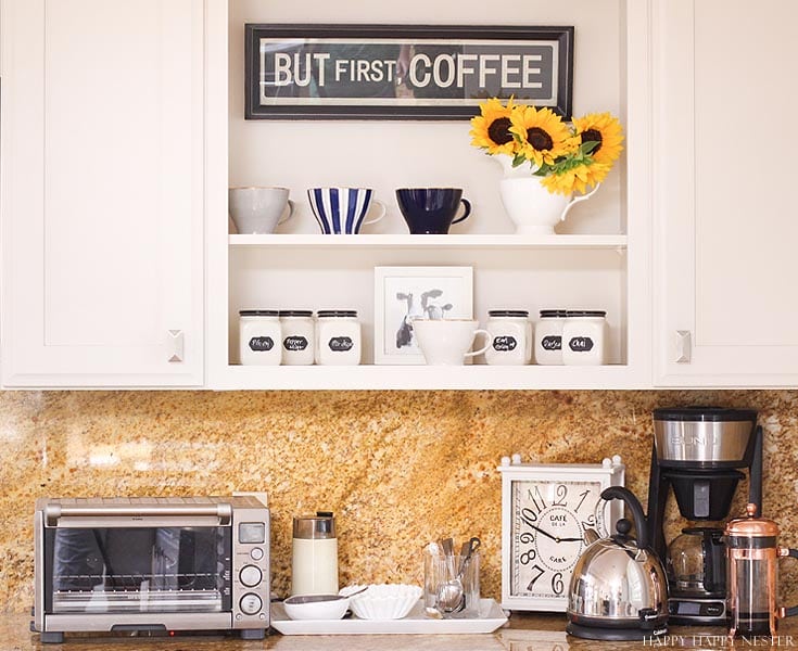 a kitchen countertop and white shelves with coffee decor