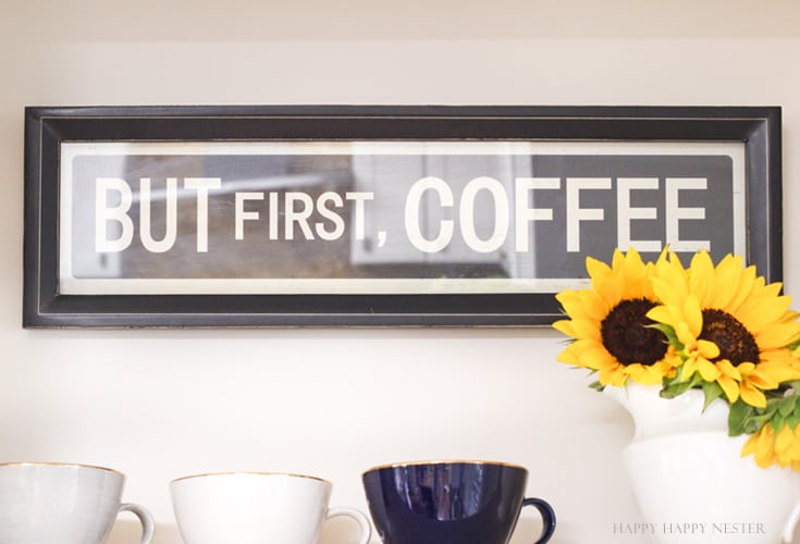 A farmhouse sign about coffee hanging on a white wall