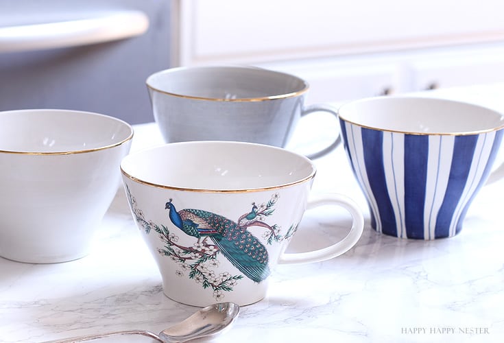 four mugs on a counter top in a kitchen