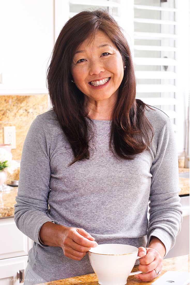 a woman in a kitchen with a coffee mug