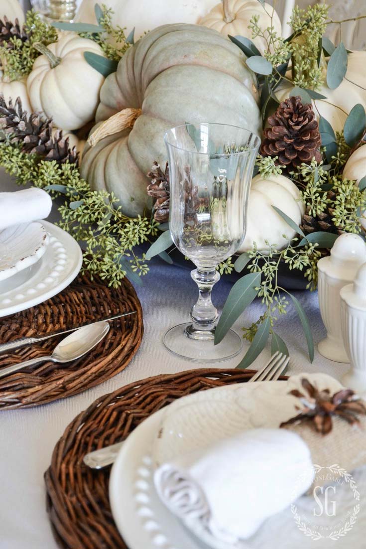 Green and white pumpkin as a centerpiece on a white table