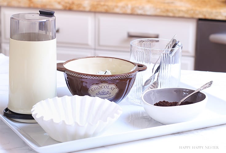 coffee items on a white tray in the kitchen