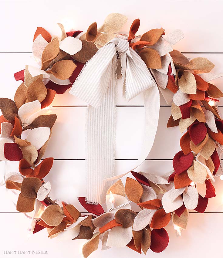 felt leaf wreath with twinkle lights on white wall