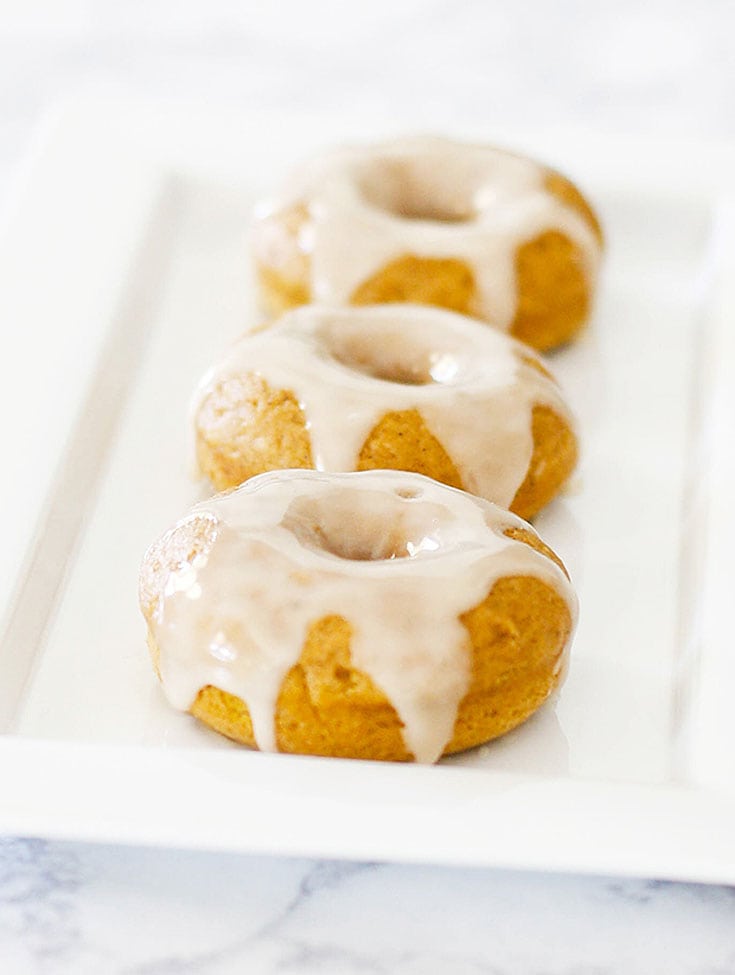 glazed donuts on a white platter