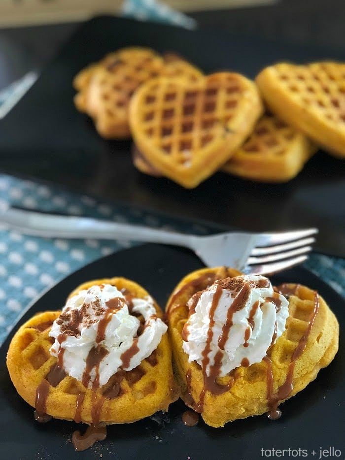 heart shaped pumpkin waffles on blue and white checkered table cloth