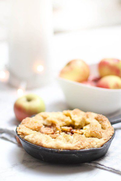 My mini apple tart recipe is baked in a mini cast iron pans. The pans create a crispy crust that is better than the typical apple pie. This apple dessert is similar to a rustic apple tart recipe but it has a scrumptious custard addition. #appletart #desserts #baking #miniappletart #applepie