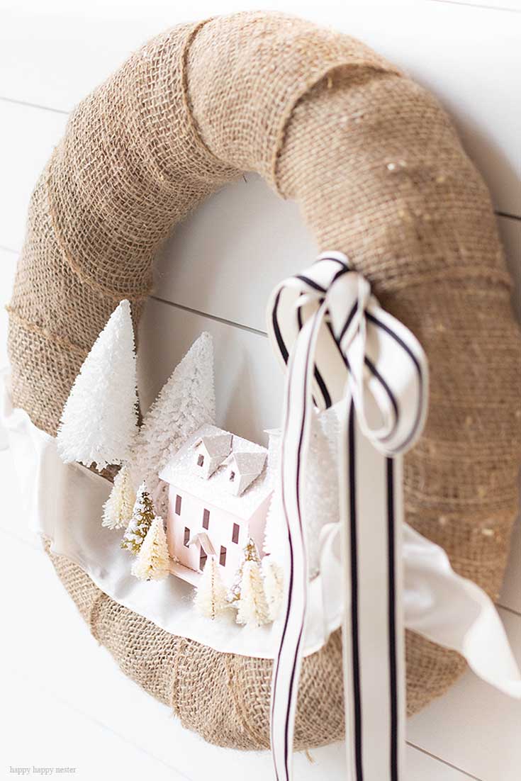 Make this DIY Christmas Village Wreath with homemade putz houses. Add some bottle brush trees, ribbon and you have a personal holiday wreath. | Crafts | Wreaths | Holiday Wreaths | Putz Houses | DIY Wreaths | DIY | Wreath Making | Cute Wreaths | Mini Village Houses | Homemade Wreaths | Martha Stewarts Village Wreath |