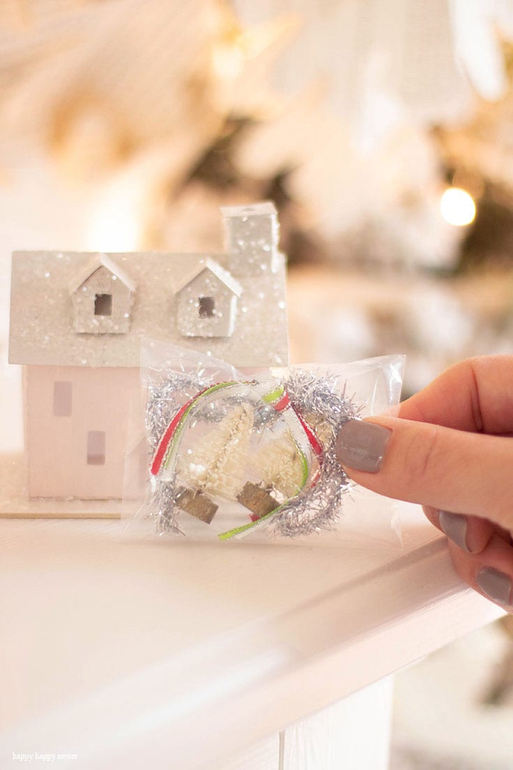 Make this DIY Christmas Village Wreath with homemade putz houses. Add some bottle brush trees, ribbon and you have a personal holiday wreath. | Crafts | Wreaths | Holiday Wreaths | Putz Houses | DIY Wreaths | DIY | Wreath Making | Cute Wreaths | Mini Village Houses | Homemade Wreaths | Martha Stewarts Village Wreath |