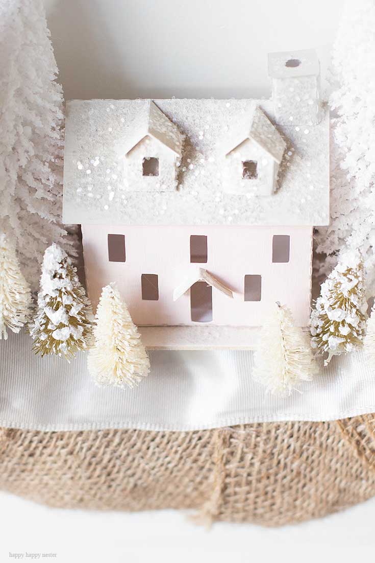 Make this DIY Christmas Village Wreath with homemade putz houses. Add some bottle brush trees, ribbon and you have a personal holiday wreath. | Crafts | Wreaths | Holiday Wreaths | Putz Houses | DIY Wreaths | DIY | Wreath Making | Cute Wreaths | Mini Village Houses | Homemade Wreaths | Martha Stewarts Village Wreath |