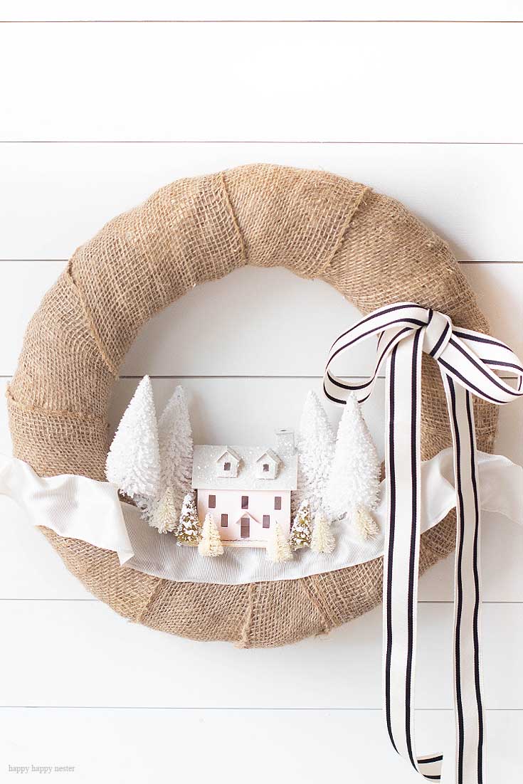 Make this DIY Christmas Village Wreath with homemade putz houses. Add some bottle brush trees, ribbon and you have a personal holiday wreath. | Crafts | Wreaths | Holiday Wreaths | Putz Houses | DIY Wreaths | DIY | Wreath Making | Cute Wreaths | Mini Village Houses | Homemade Wreaths | Martha Stewarts Village Wreath |