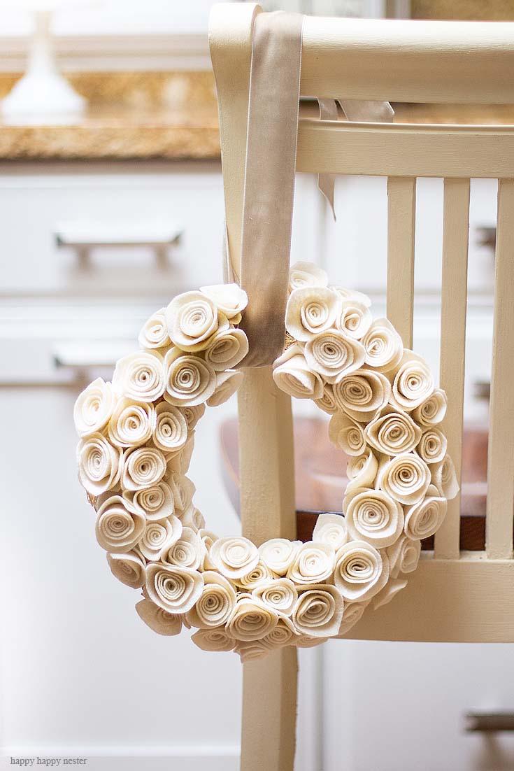 This Rosette Felt Wreath Tutorial makes a beautiful wreath. You'll find it easy to make. The neutral color will go with any decor, and it can be displayed all year long. So, make sure to create this felt flower wreath with these cute felt rosettes. 