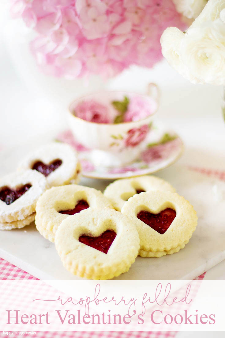 This Raspberry Filled Valentine's Heart Cookie Recipe is the perfect dessert for a dinner or a party. Give them away as a Valentine's Day gift for a friend. Sprinkle them with powdered sugar for an extra-amazing sugar cookie. Cookie | Baking | Valentine's Day Treats | Cookie Recipe | Raspberry Filled Cookies