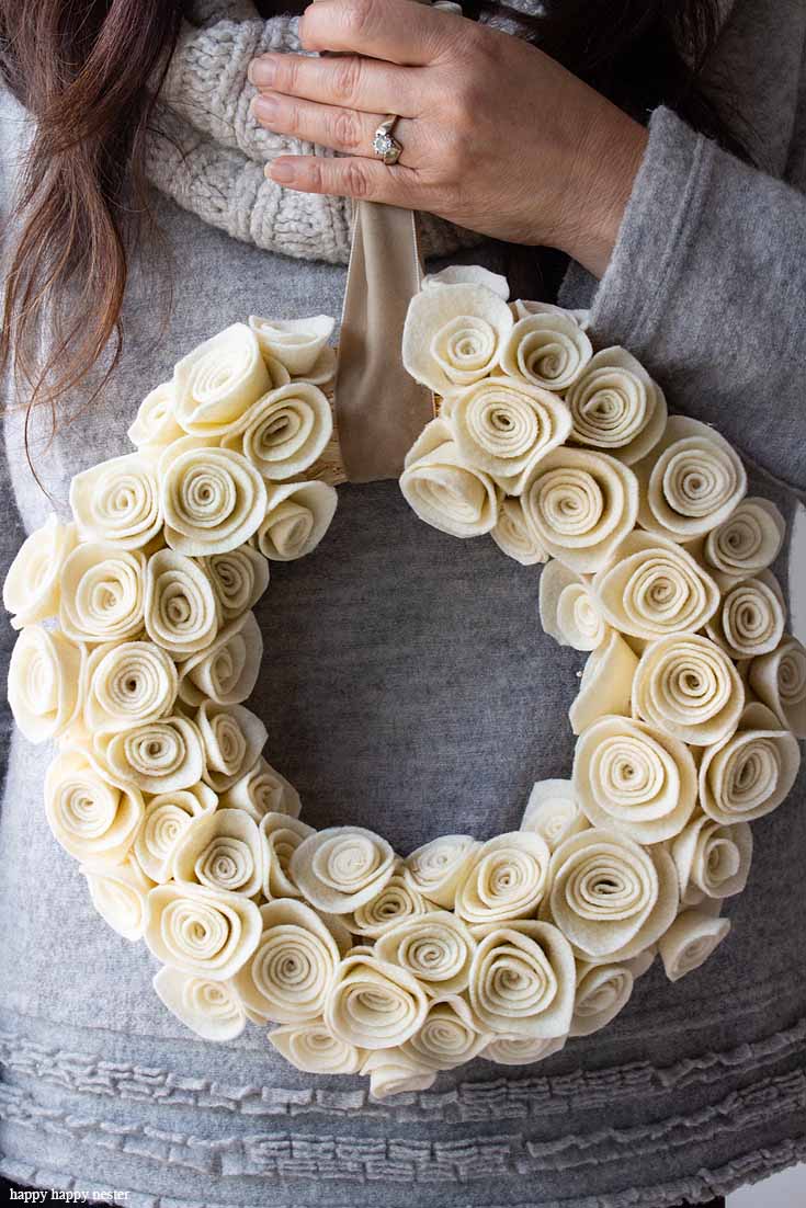 This Rosette Felt Wreath Tutorial makes a beautiful wreath. You'll find it easy to make. The neutral color will go with any decor, and it can be displayed all year long. So, make sure to create this felt flower wreath with these cute felt rosettes. 